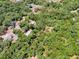Aerial view of a wooded parcel of land outlined in red at 1203 High St, Wildwood, FL 34785