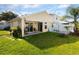 Spacious backyard featuring green grass, covered patio, privacy fence, and room for entertaining at 12430 Ne 52Nd Loop, Oxford, FL 34484
