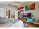 Bright bedroom with a view into the ensuite bathroom, showing off the colorful decor at 12430 Ne 52Nd Loop, Oxford, FL 34484