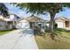 Charming single-story home featuring a well-maintained yard and inviting front porch with swing at 12430 Ne 52Nd Loop, Oxford, FL 34484