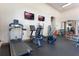 Well-equipped gym featuring a treadmill, elliptical, stationary bike, and weightlifting equipment at 12430 Ne 52Nd Loop, Oxford, FL 34484