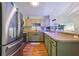 Contemporary kitchen with stainless steel refrigerator, sleek countertops, and light-colored cabinetry at 12430 Ne 52Nd Loop, Oxford, FL 34484