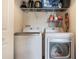 A full sized washer and dryer set and storage shelves are featured in the laundry room at 12430 Ne 52Nd Loop, Oxford, FL 34484