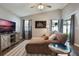 Comfortable living room with vaulted ceiling, ceiling fan, contemporary decor, and sliding glass doors at 12430 Ne 52Nd Loop, Oxford, FL 34484