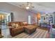 Spacious living area with open layout to kitchen, featuring a large sectional and stylish decor at 12430 Ne 52Nd Loop, Oxford, FL 34484