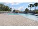 Community pool featuring a beach entry, multiple lounge chairs and an exterior gazebo at 12430 Ne 52Nd Loop, Oxford, FL 34484