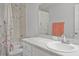 Bathroom with a bathtub shower combo with a floral shower curtain and a white vanity at 1247 Mezzavalle Way, Auburndale, FL 33823