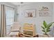 Charming Bedroom with a cozy chair, crib, and decorative shelves creating a peaceful space at 1247 Mezzavalle Way, Auburndale, FL 33823