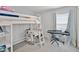 Bright bedroom with loft bed, desk, keyboard, and colorful curtains at 1247 Mezzavalle Way, Auburndale, FL 33823