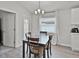 Dining room with wood-look flooring, modern light fixture, and views to backyard at 1247 Mezzavalle Way, Auburndale, FL 33823