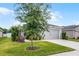 Exterior shot of a single Gathering home, well manicured, blue skies and healthy lawn at 1247 Mezzavalle Way, Auburndale, FL 33823