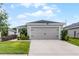 Charming single Gathering home with neutral paint, two-car garage, and manicured landscaping at 1247 Mezzavalle Way, Auburndale, FL 33823