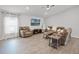 Spacious living room with neutral walls, wood-look flooring, and stylish furnishings at 1247 Mezzavalle Way, Auburndale, FL 33823