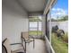 Cozy screened-in patio with two chairs overlooking a well-maintained backyard at 1247 Mezzavalle Way, Auburndale, FL 33823