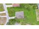 Aerial view of a well-maintained home and lawn surrounded by mature trees and neighborhood streets at 12512 Lake Ridge Cir, Clermont, FL 34711