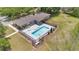 Overhead view of a community pool area, surrounded by lush greenery and outdoor seating at 12512 Lake Ridge Cir, Clermont, FL 34711