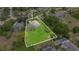 Aerial view of a home on a well-manicured lot, highlighted by a property line outline at 12512 Lake Ridge Cir, Clermont, FL 34711