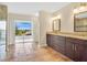 Bright bathroom with a dual sink vanity, terra cotta tile floors, and access to an outdoor balcony at 12512 Lake Ridge Cir, Clermont, FL 34711