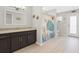 Bathroom featuring a single sink vanity, granite countertop, dark wood cabinets, and decorative sea-themed shower curtain at 12512 Lake Ridge Cir, Clermont, FL 34711