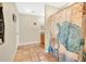 Cozy bathroom with terra cotta floors, vanity, and shower featuring a decorative curtain at 12512 Lake Ridge Cir, Clermont, FL 34711
