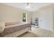 Well-lit bedroom with a ceiling fan and a large window overlooking the backyard at 12512 Lake Ridge Cir, Clermont, FL 34711