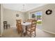 Inviting dining room with a large window and chandelier, perfect for Gathering meals and entertaining guests at 12512 Lake Ridge Cir, Clermont, FL 34711