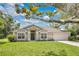Charming single-story home with a lush green lawn and well-maintained landscaping, enhancing its curb appeal at 12512 Lake Ridge Cir, Clermont, FL 34711