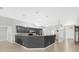 Large kitchen boasts long breakfast bar, stainless steel appliances, gray cabinets, and modern pendant lights at 12512 Lake Ridge Cir, Clermont, FL 34711