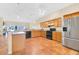 Modern kitchen with stainless steel appliances, wood cabinets, and spacious countertops for cooking and dining at 12512 Lake Ridge Cir, Clermont, FL 34711