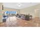 Bright and inviting living room with terracotta tile, offering comfortable seating and a view of the outdoors at 12512 Lake Ridge Cir, Clermont, FL 34711