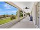 Enjoy outdoor living on this covered patio with ceiling fans and view of backyard and blue skies at 12512 Lake Ridge Cir, Clermont, FL 34711