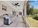 Relax on the spacious screened patio, perfect for entertaining, with a grill and backyard views at 12512 Lake Ridge Cir, Clermont, FL 34711