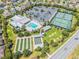 Aerial view of community pool, clubhouse, bocce ball and tennis courts at 1309 Piney Woods Path, The Villages, FL 32163