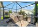 Backyard patio features a built-in hot tub for outdoor relaxation and a stainless steel grill for BBQ at 1309 Piney Woods Path, The Villages, FL 32163