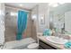 Bathroom featuring tub, shower, seashell decor, and blue accents at 1309 Piney Woods Path, The Villages, FL 32163