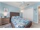Bedroom features ceiling fan, spacious closet, and a neutral color palette at 1309 Piney Woods Path, The Villages, FL 32163