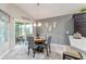Cozy dining area with a round table, four chairs, and a sliding glass door to the outside at 1309 Piney Woods Path, The Villages, FL 32163