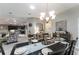 Dining room with tile floors open to kitchen and living areas at 1309 Piney Woods Path, The Villages, FL 32163