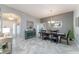 Spacious dining room featuring tile floors and an elegant chandelier at 1309 Piney Woods Path, The Villages, FL 32163