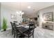 Bright dining area open to the living room and kitchen with tile floors at 1309 Piney Woods Path, The Villages, FL 32163