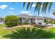 Charming home exterior with manicured lawn and mature landscaping at 1309 Piney Woods Path, The Villages, FL 32163