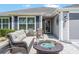 Cozy front porch sitting area with fire table at 1309 Piney Woods Path, The Villages, FL 32163