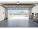 View from garage to street, with epoxy floor, painted walls, and storage space at 1309 Piney Woods Path, The Villages, FL 32163