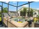 Outdoor hot tub in screened patio is perfect for relaxing, with seating, jets, and room for several people at 1309 Piney Woods Path, The Villages, FL 32163