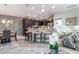 Open-concept kitchen featuring a stone-accented island, stainless steel appliances, and dark wood cabinetry at 1309 Piney Woods Path, The Villages, FL 32163