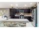 Beautiful kitchen featuring stainless steel appliances and dark wood cabinetry at 1309 Piney Woods Path, The Villages, FL 32163