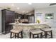 Kitchen island with a stone accent and stainless steel appliances at 1309 Piney Woods Path, The Villages, FL 32163