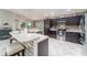 A spacious kitchen with stainless steel appliances, dark wood cabinets, and a breakfast bar at 1309 Piney Woods Path, The Villages, FL 32163