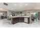 Modern kitchen with stainless steel appliances and island with dark wood cabinets at 1309 Piney Woods Path, The Villages, FL 32163
