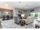 Living area with tile floors adjacent to dining area and large sliding glass door at 1309 Piney Woods Path, The Villages, FL 32163